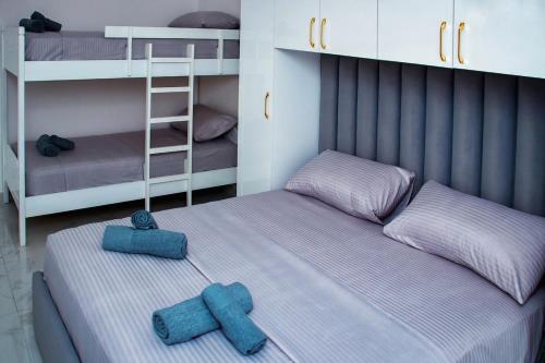 two twin beds in a room with bunk beds at Flat in Shëngjin Beachfront Getaway in Shëngjin
