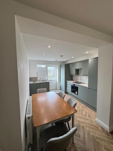 a kitchen with a table and chairs in a room at 18 Morawel in Burry Port
