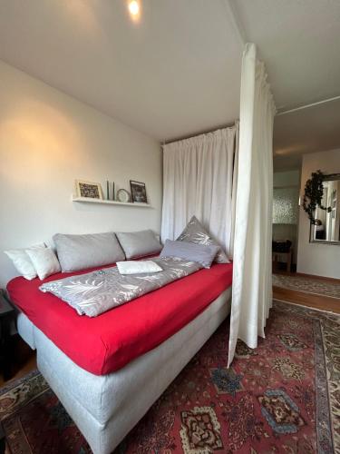 a bedroom with a bed with a red blanket at FeWo Parkblick mit 2 Bädern in Bad Harzburg