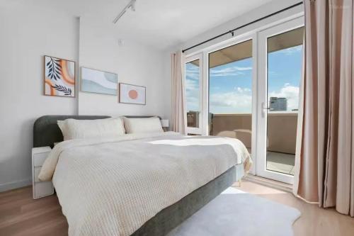 a bedroom with a bed and a large window at Cozy 2BD Westminster Apartment in London