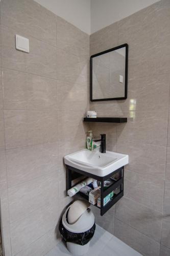 a bathroom with a sink and a mirror at Open Gate House in Arusha