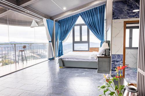 a bedroom with a bed and a balcony at Sun Heaven Dalat in Xuân Trường