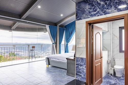 a bedroom with a bed and a balcony at Sun Heaven Dalat in Xuân Trường