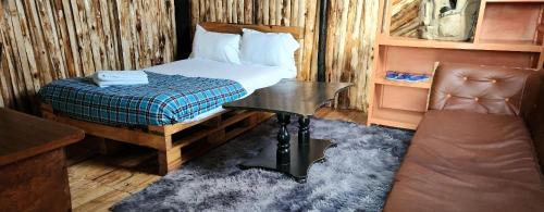 a bedroom with a bed and a desk and a chair at Mambo Game View in Elmenteita