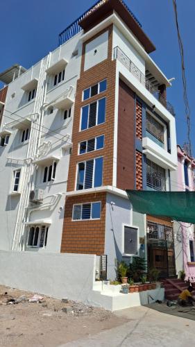 a tall apartment building with a building at Roshni Apartment - Ground Floor in Vishāram