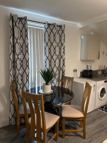 a kitchen and dining room with a table and chairs at Crosby Apartments in Liverpool