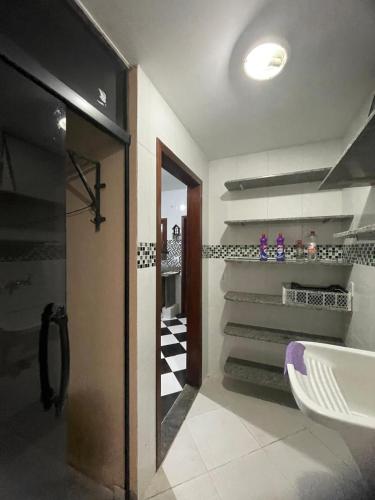a bathroom with a walk in shower and a sink at CAIPORA Hostel Lagoa in Saquarema