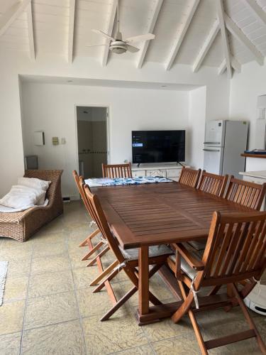 a dining room with a wooden table and chairs at Blue House in San Pedro