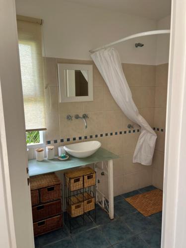 a bathroom with a sink and a mirror at Blue House in San Pedro