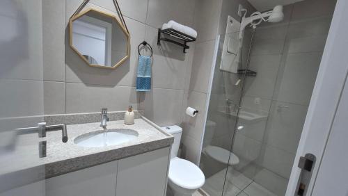 a bathroom with a sink and a toilet and a shower at Studio Mare Alta in Tamandaré