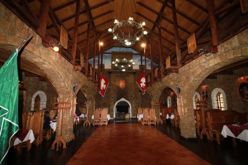 a large room with chairs and a chandelier in a building at Satori in Migovo