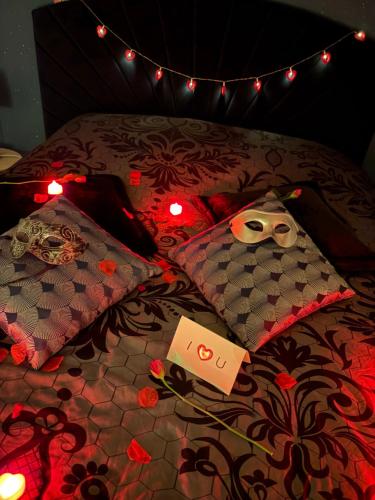 a bed with two pillows and a mask on it at La parenthèse secrète in Danvou