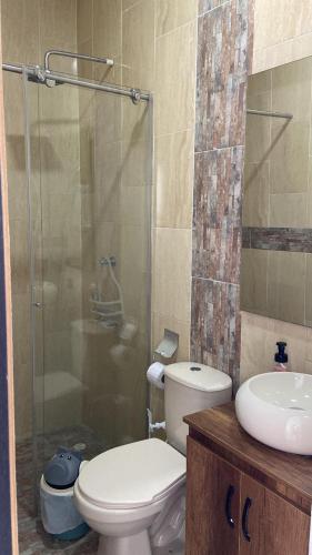 a bathroom with a toilet and a sink and a shower at Casa o Habitación in Villeta