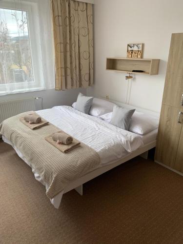 a bedroom with a bed with two towels on it at Privat Alfa in Hrabušice