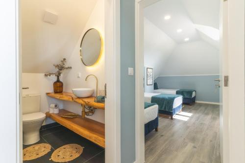 a bathroom with a sink and a toilet in a room at Casa da Horta by Atlantic Holiday in Santa Cruz