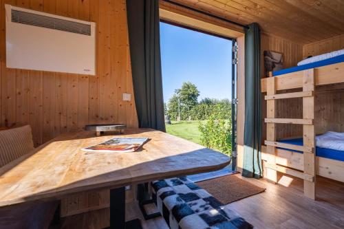 a table in a tiny house with a window at Tinyhouse Spiegelpeer in Ruinerwold