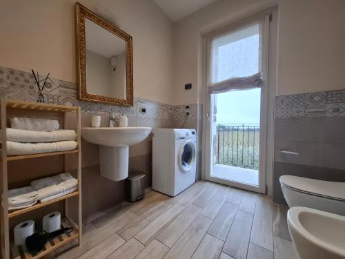 a bathroom with a sink and a washing machine at Villa Poggio Bardolino in Bardolino