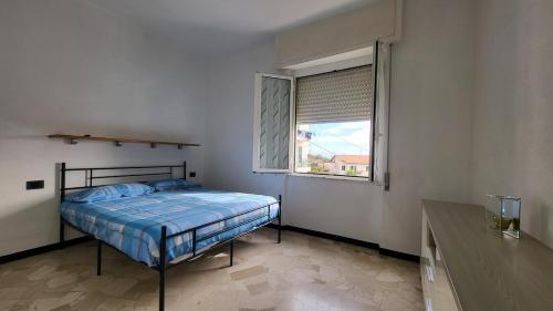 a bedroom with a bed and a window at Vista dai pini in Varazze