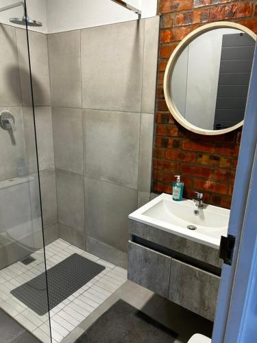 a bathroom with a sink and a mirror at Alicante in Worcester