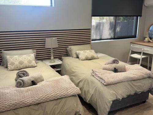 a bedroom with two beds with stuffed animals on them at Alicante in Worcester