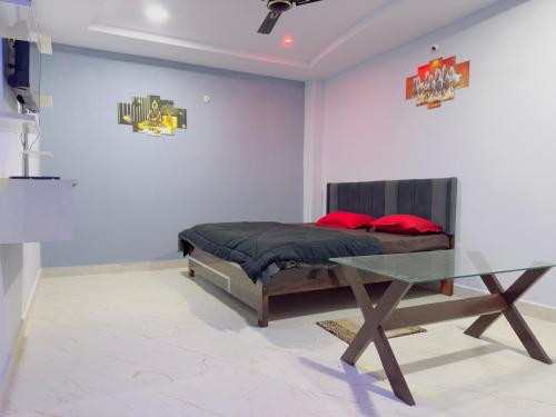 a bedroom with a bed and a glass table at Hotel Paradise in Rewa