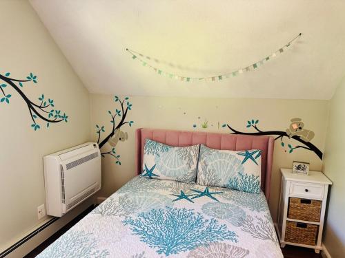 a bedroom with a bed with a pink head board at Cape Cod Retreat, Osterville Beach Pass in Osterville