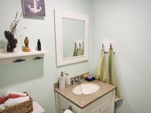a bathroom with a sink and a mirror at Cape Cod Retreat, Osterville Beach Pass in Osterville