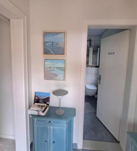 a bathroom with a blue table with a book on it at Ferienhäuschen blauer See in Bockhorn