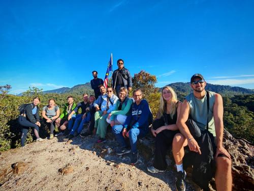 a group of people sitting on top of a mountain at A3A Oastel CoLiving - Children NO Allowed in Tanah Rata