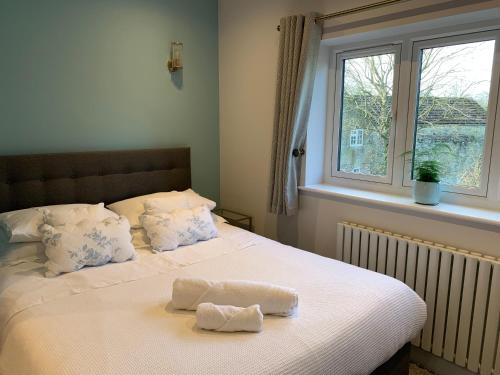 a bed with two towels on it in a bedroom at Park View Guest Suite in South Milford