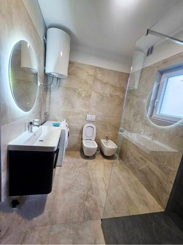 a bathroom with a sink and a toilet at Kuća Sonja in Vranje