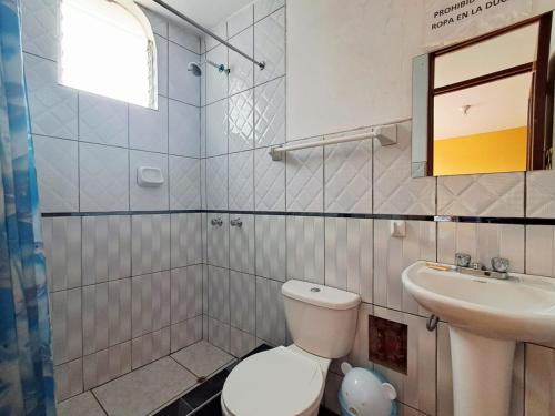a bathroom with a toilet and a sink at Belen Achomani in Chivay