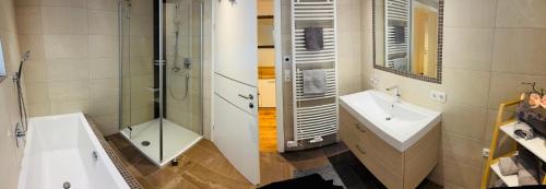 a bathroom with a shower and a sink and a tub at Bei die Gstrein's in See