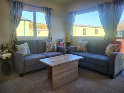 a living room with a couch and a coffee table at Nidd Way Holiday Let in Knaresborough