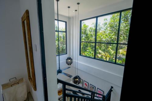 a room with two windows and a door at Virgo Sun House in Uluwatu