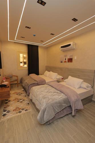 a hotel room with two beds in a room at El Mandara Residence Inn in Alexandria