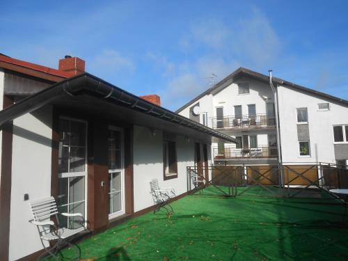 a balcony of a house with a green lawn at Robinzon in Kaliningrad