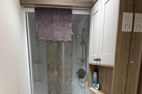 a shower with a glass door in a bathroom at The Royal Oak - Sleeps 4 - Deck - Free Parking in Holsworthy
