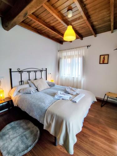 a bedroom with a large bed in a room at Casa Chisco in Cudillero