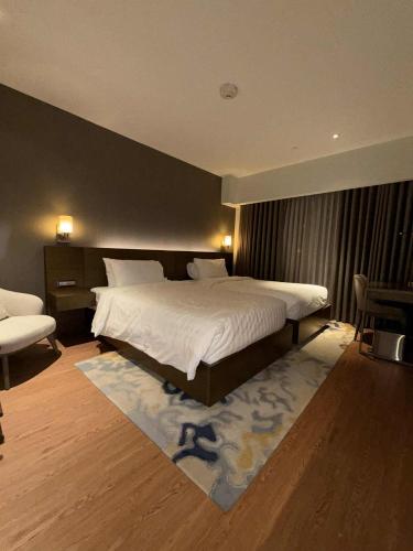 a bedroom with a large white bed in a room at Novotel at Acqua, The Hotel Residences by RM in Manila