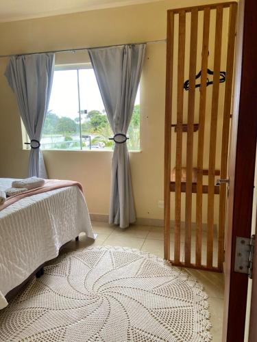 a bedroom with a bed and a large window at Apartamento vita bella in Porto Velho