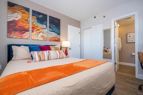 a bedroom with a large bed with colorful pillows at Lakeview 2 suites 6 min to New EPIC Universe in Orlando