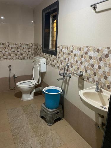 a bathroom with a toilet and a sink at Mist Leaf Villa Mahabaleshwar in Mahabaleshwar