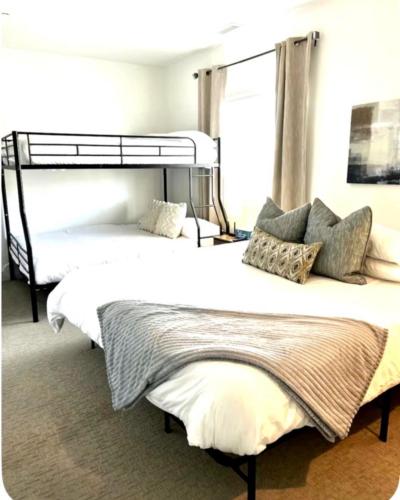 two twin beds in a room with a window at Beehive Escape -Salt Lake City in Salt Lake City