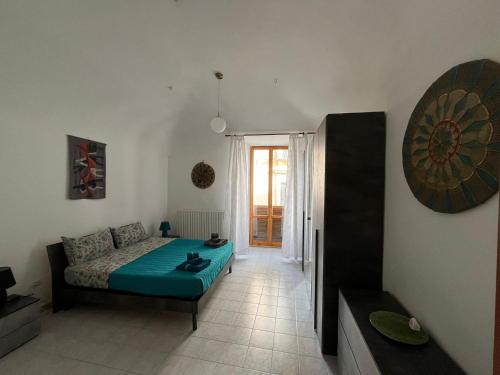 a bedroom with a bed and a room with a window at Il campanile in Sulmona