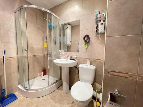 a bathroom with a shower and a toilet and a sink at Nessebar, Studio,South Beach, Larisa in Nesebar