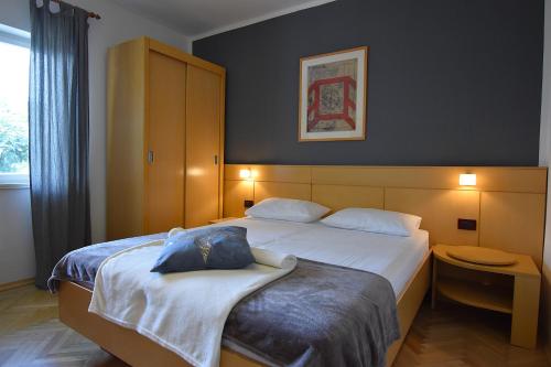 a hotel room with two beds and a window at Apartman Balen J. in Banjol