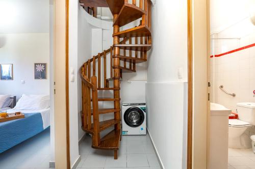 a stairway leading to a bathroom with a washing machine at Blue Bay Apartment in Gouvia