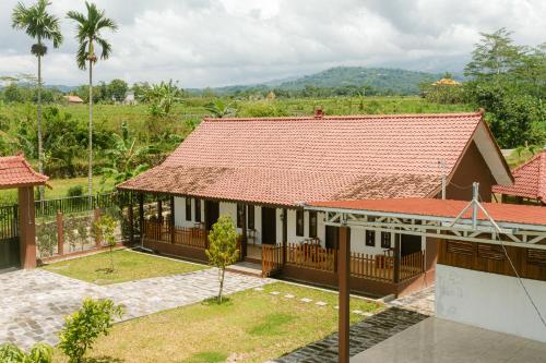 an aerial view of a house with a red roof at Omah Ulin in Bandongan