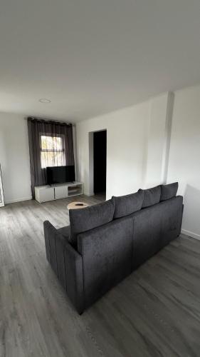 a large living room with a couch and a window at LN GuestHouse in Horta